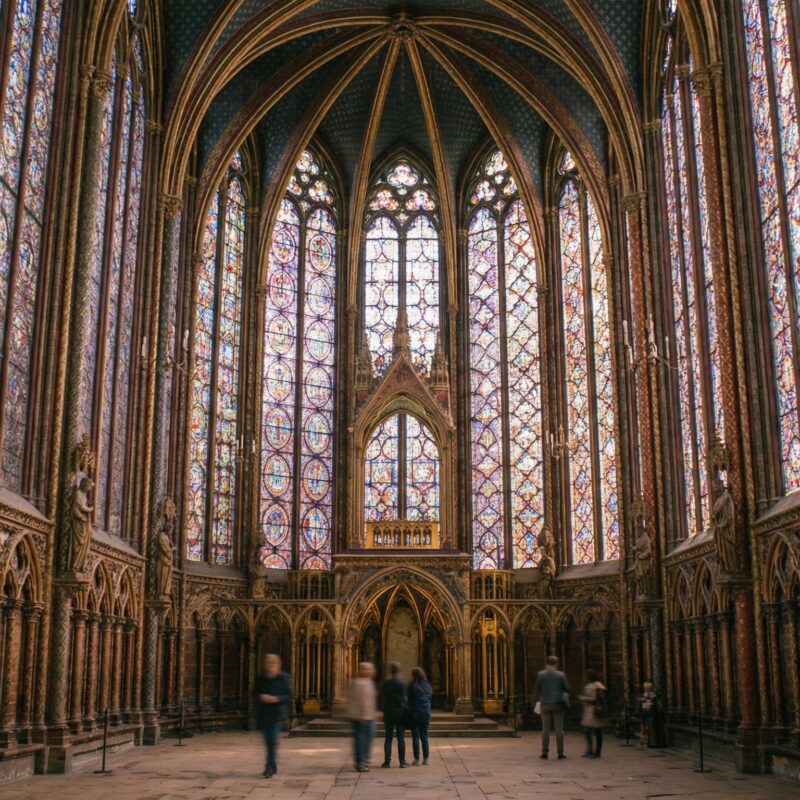 Upward view of Sainte Chapelle ceiling with Gothic arches and vibrant glass windows